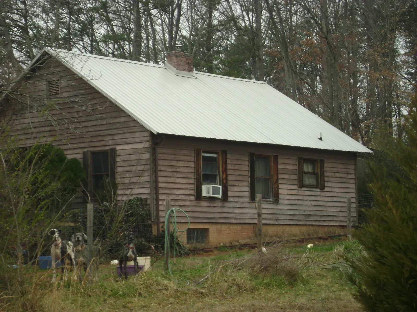 White metal roof on an old wood sided farmhouse, from a Asphalt Shingle Roof Repair job in Barrington